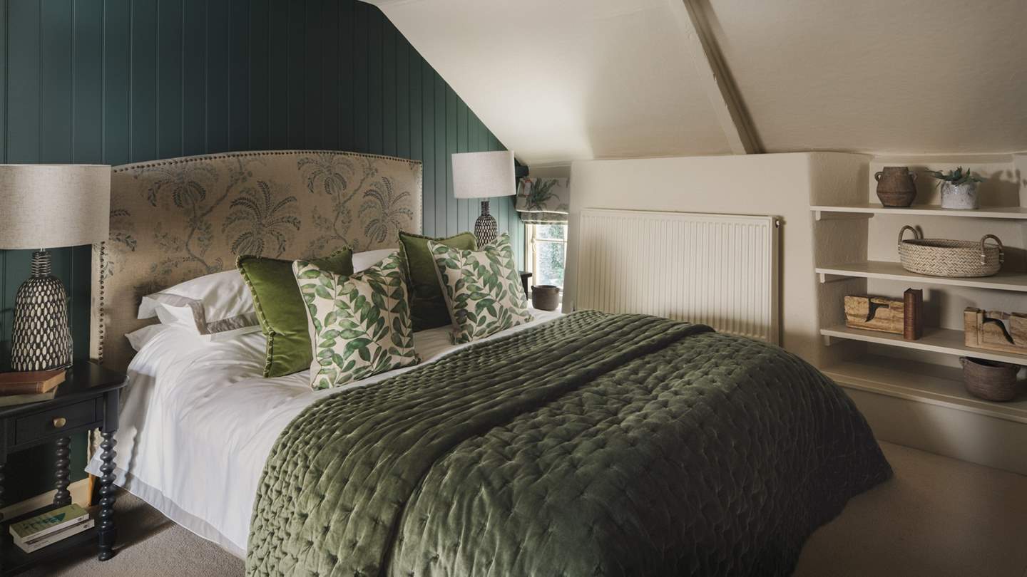 Rich teal tones invite in the second bedroom