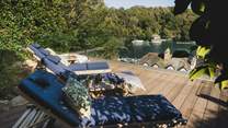 With a sleek glass balcony and an array of sun loungers, unwind beside uninterrupted river views
