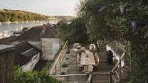 On the lower terrace awaits an array of outdoor seating, with a wooden table for eight made for sun-kissed banquets