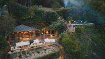 Outside, tiered gardens and a summer house promise a dreamy setting for entertaining in every season