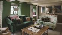 Jewel-toned green hues and rustic original beams promise a cosy space to gather for slow living moments