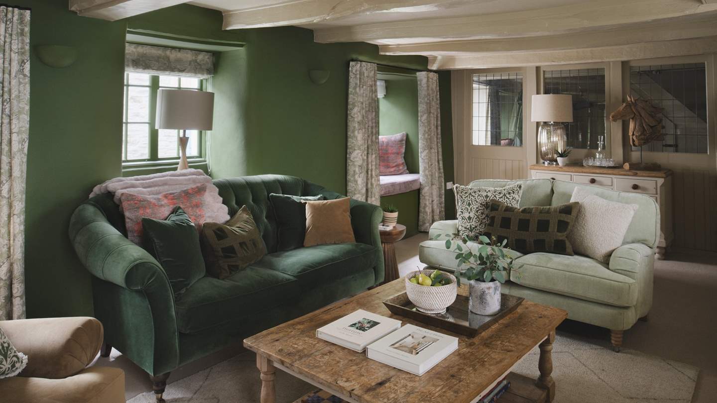 Jewel-toned green hues and rustic original beams promise a cosy space to gather for slow living moments