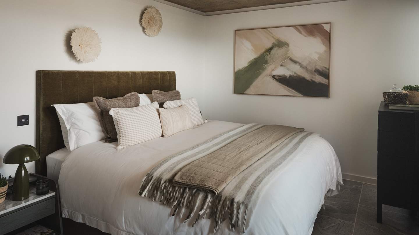 The first bedroom features a super king bed, beckoning for nights of restful repose