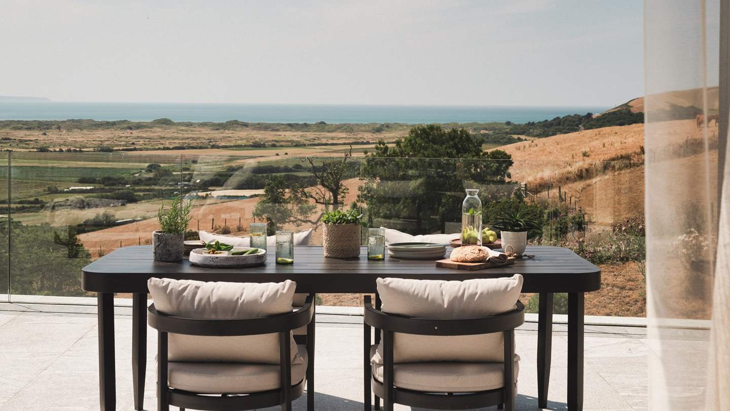 An outdoor dining table and chairs entice for alfresco feasts