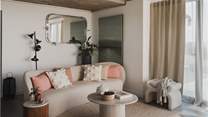 Take a seat in the sumptuous boucle sofa or one of the two armchairs and absorb the views with a glass of something special in hand