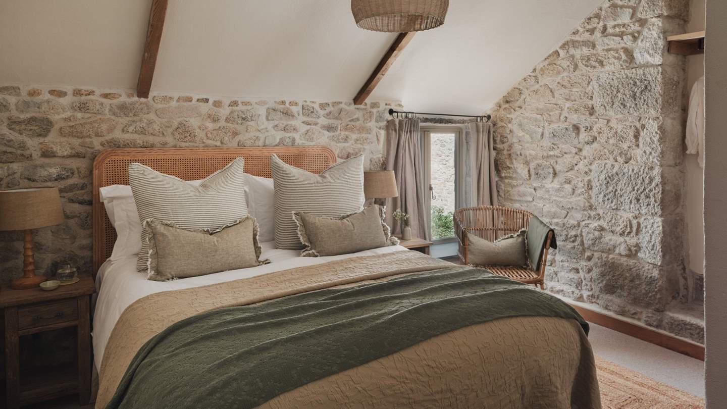 The second bedroom features a king-size bed enswathed in the finest linens