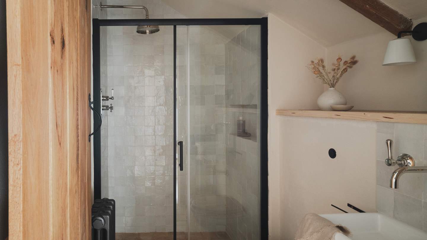 An ensuite bathroom awaits with a walk-in shower