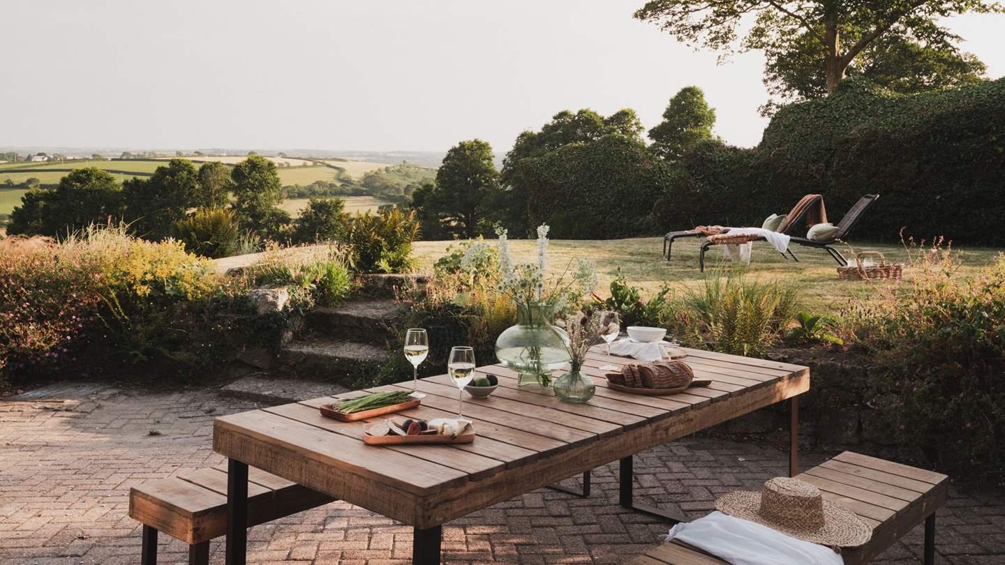 The suntrap terrace boasts an outdoor dining table hugged by bench seating, beckoning for brunches of aromatic blends and buttery pastries 