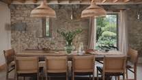 The dining room is crowned with elegant oak beams and illuminated by panoramic windows 
