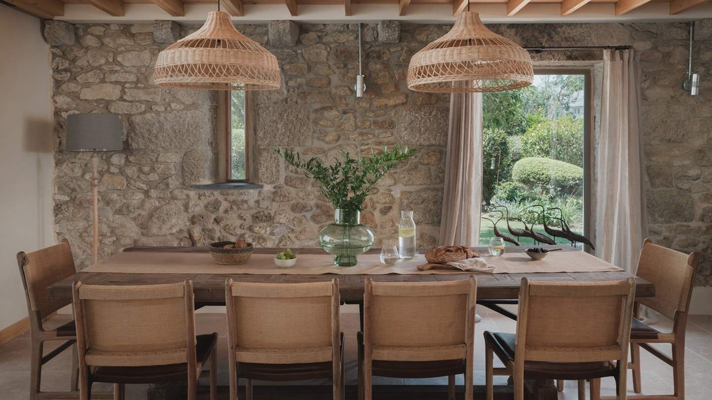 The dining room is crowned with elegant oak beams and illuminated by panoramic windows 