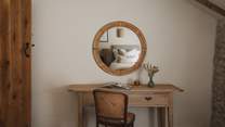 A dressing table resides at the far side of the room