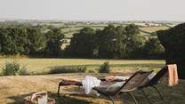 On the lawn, sun loungers call for moments lost between pages

