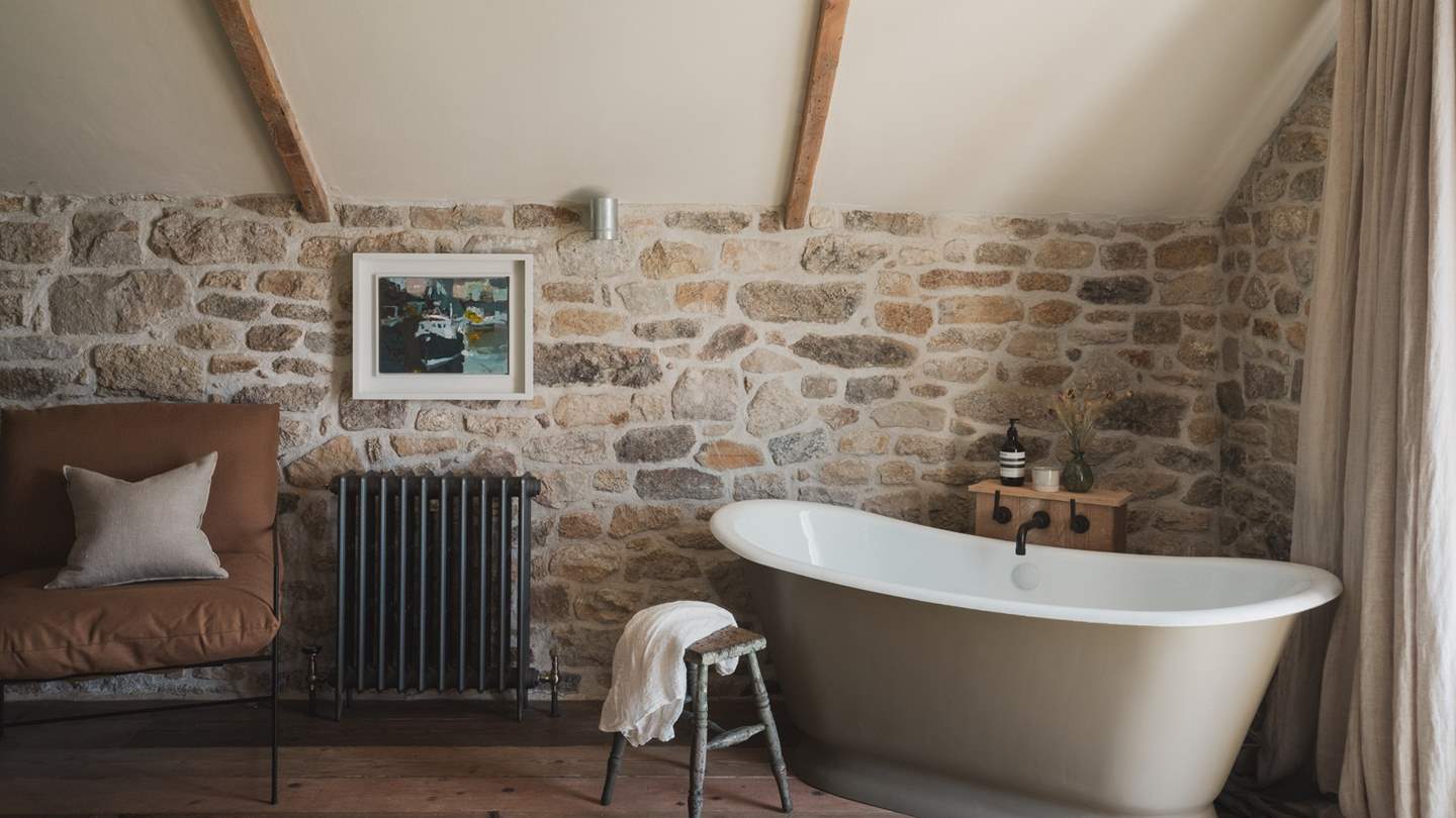Encouraging moments of bubble-topped bliss, a freestanding rolltop bath overlooks reaching country vistas