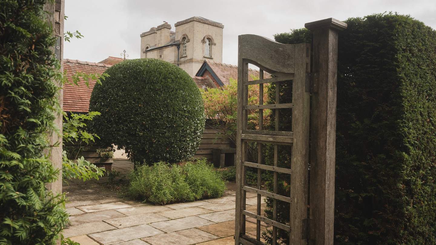 Discover the patio framed by curated yew trees