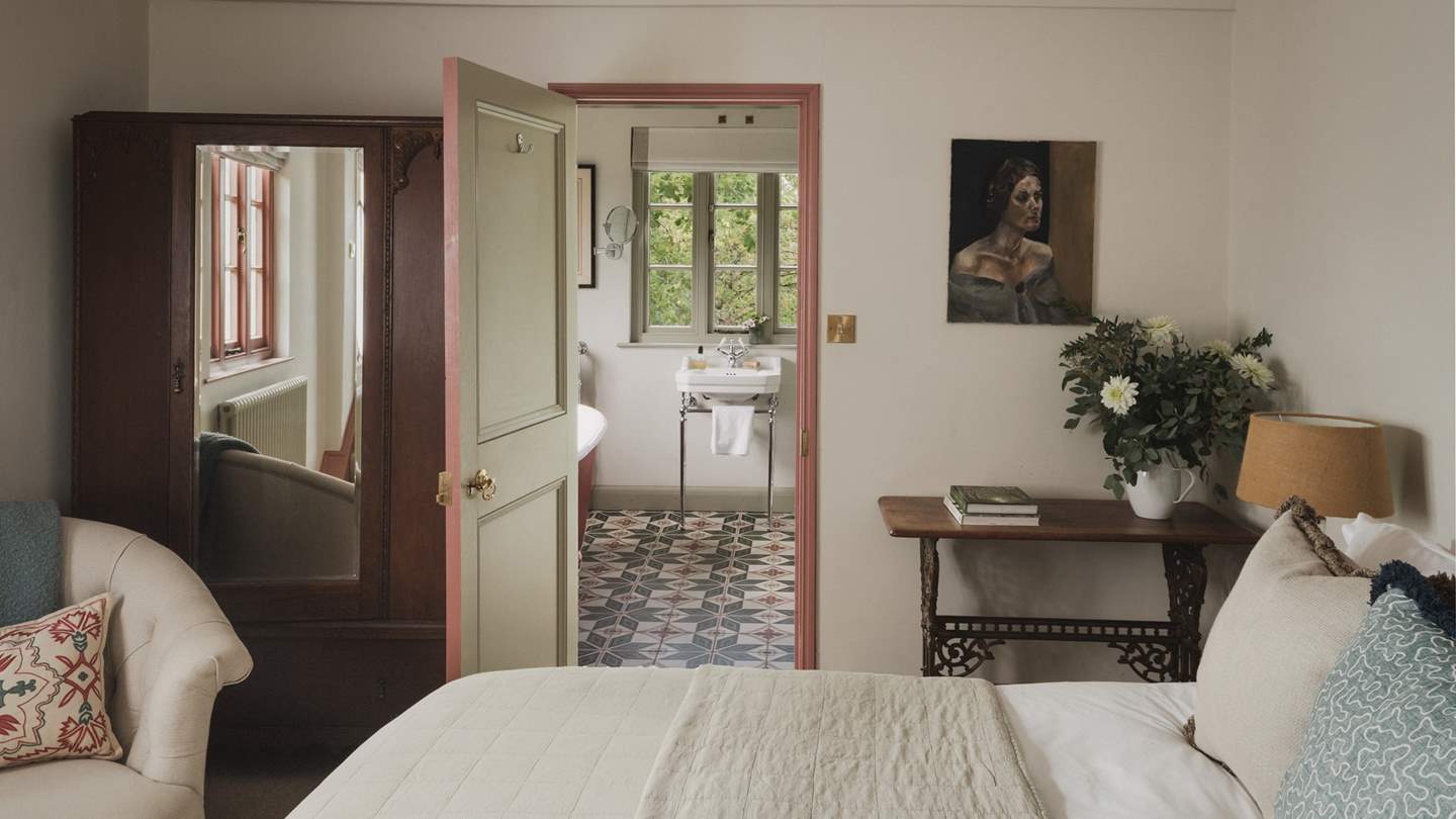 Uncover a blend of antique pieces and contemporary touches in this soft-hued sanctuary