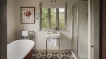 A free-standing bathtub promises slow mornings and soothing evening soaks