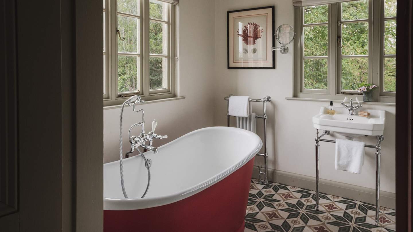 Through the blush-tinted door, a beautiful en suite resides