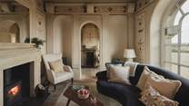 A wood burning stove invites for cosy evenings in the Renaissance-inspired living room 