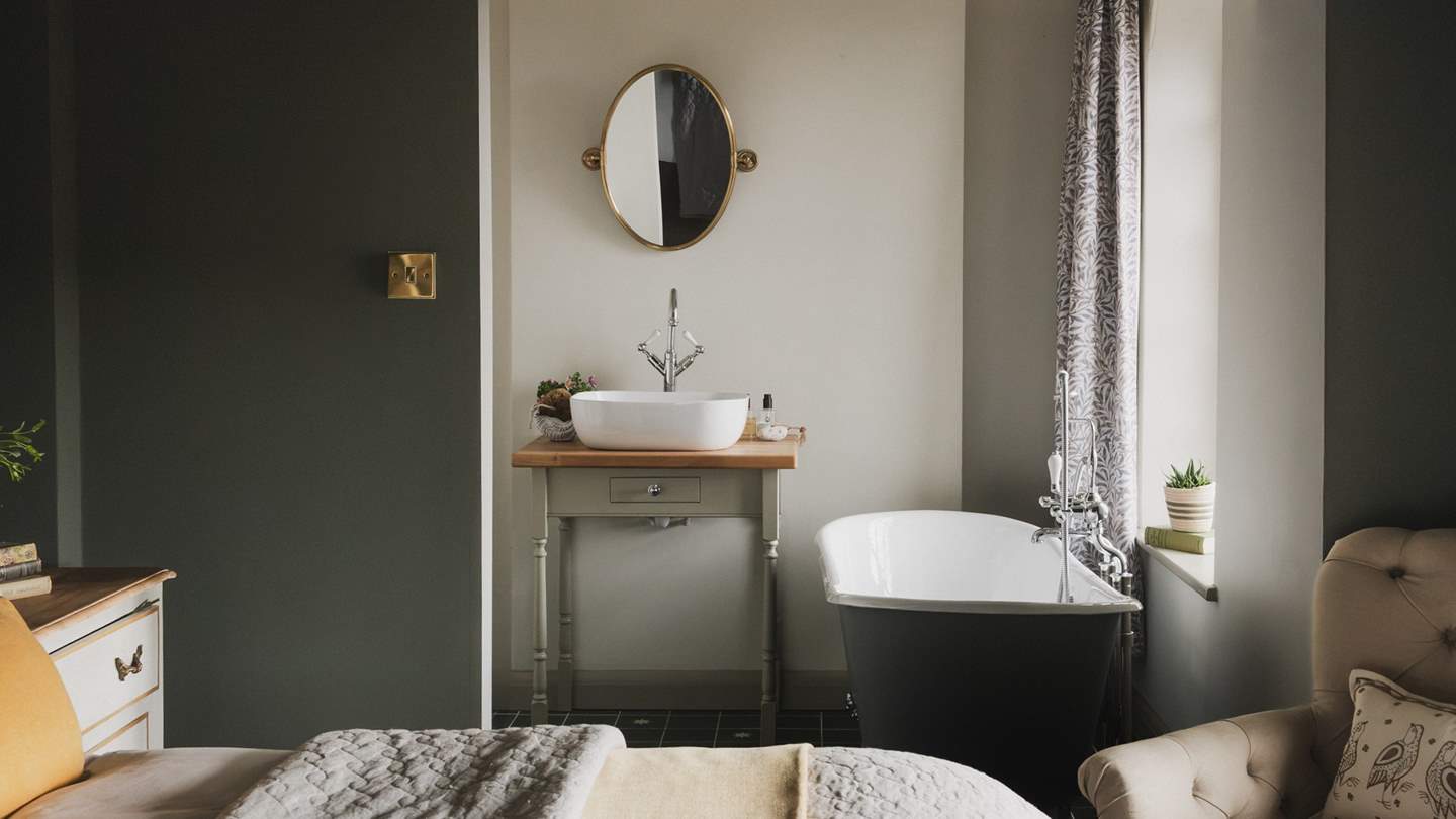 The en suite bathroom awaits within an alcove