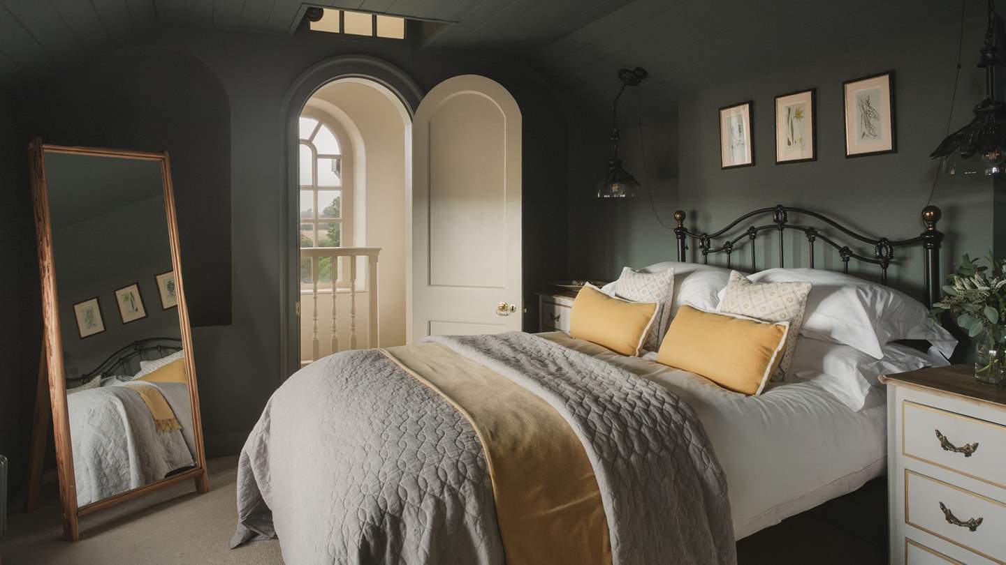 In the second bedroom, deeper tones invite soothing slumber within a plush king size bed
