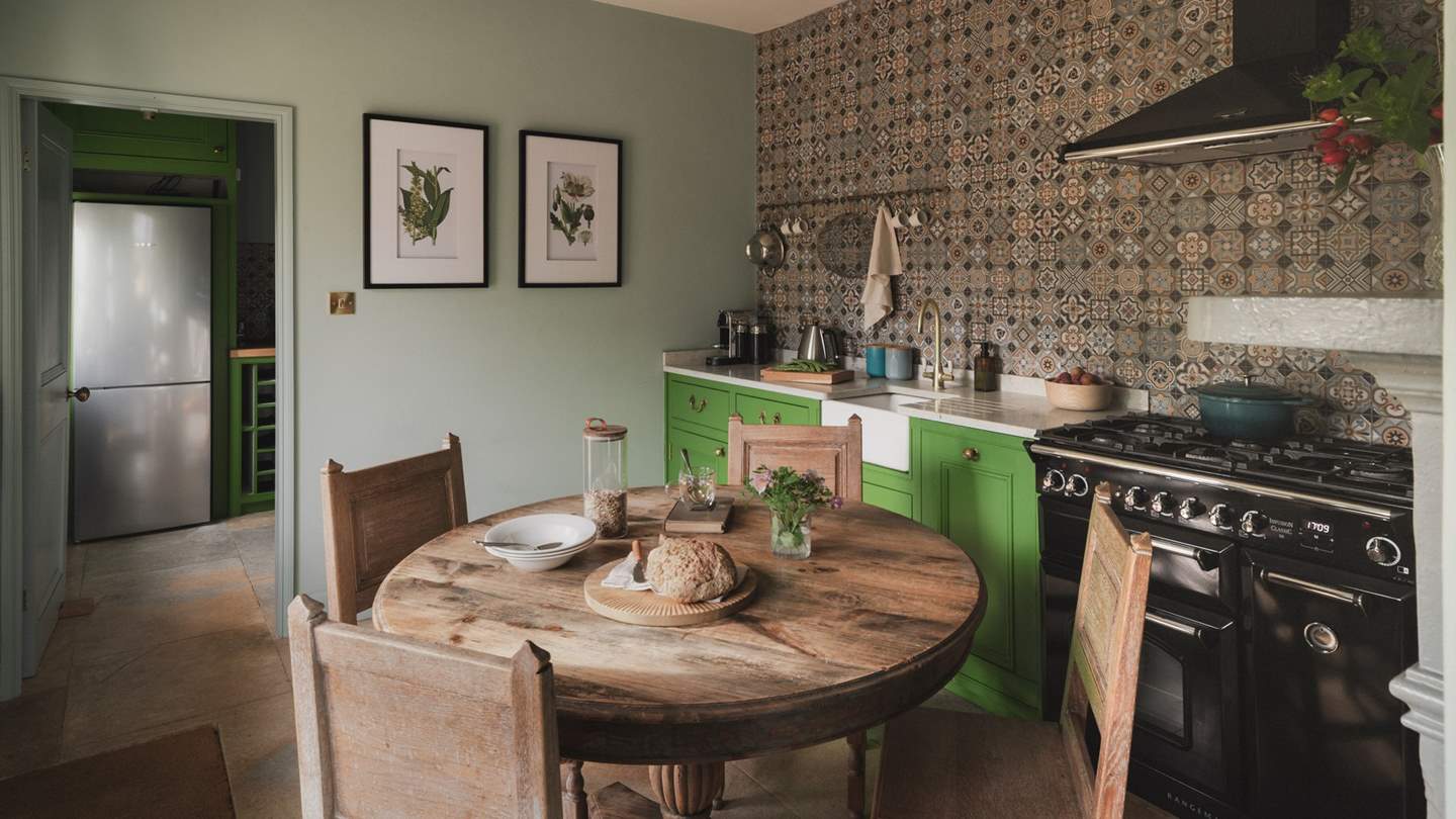 Discover verdant hues in the kitchen, where a combination stove sits at its heart