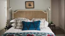 Here you'll find a king-size bed with a braided rattan headboard