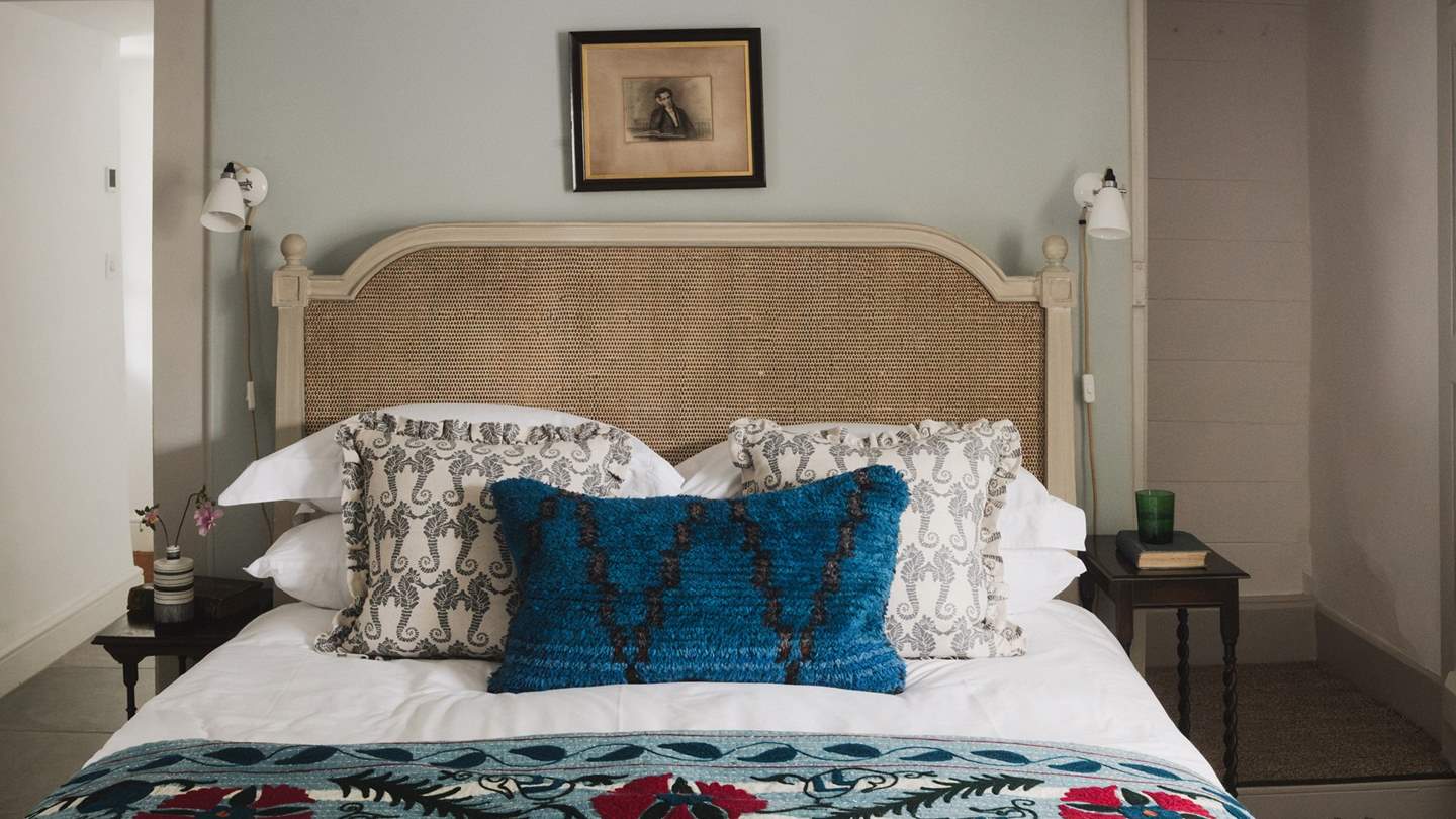 Here you'll find a king-size bed with a braided rattan headboard