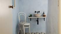 Powder blue walls and mosaic tiles set the scene for rejuvenating wake-ups