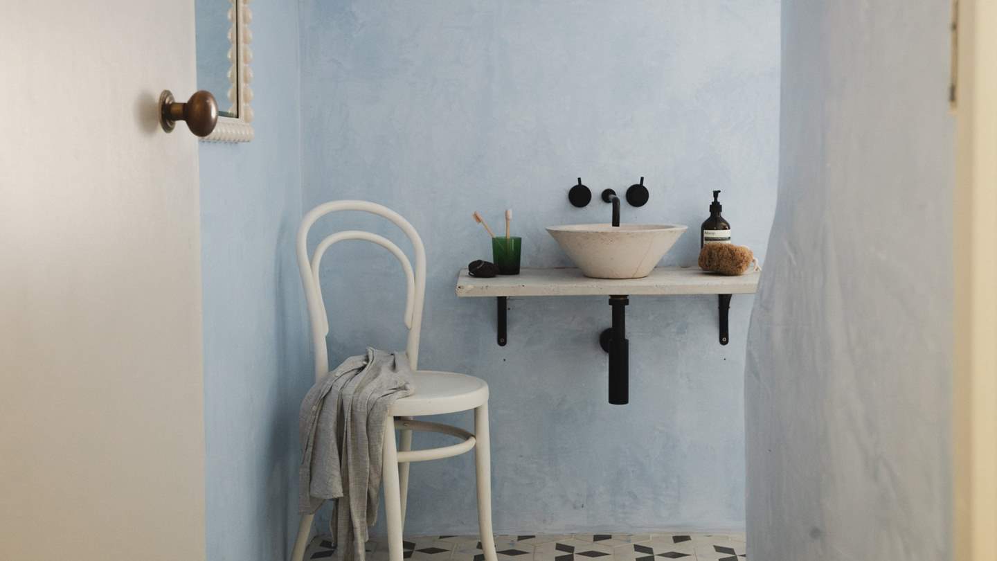 Powder blue walls and mosaic tiles set the scene for rejuvenating wake-ups