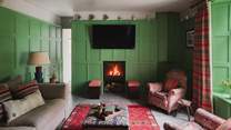 Beckoning screen enthusiasts is the inviting snug, complete with a contemporary wood burning stove