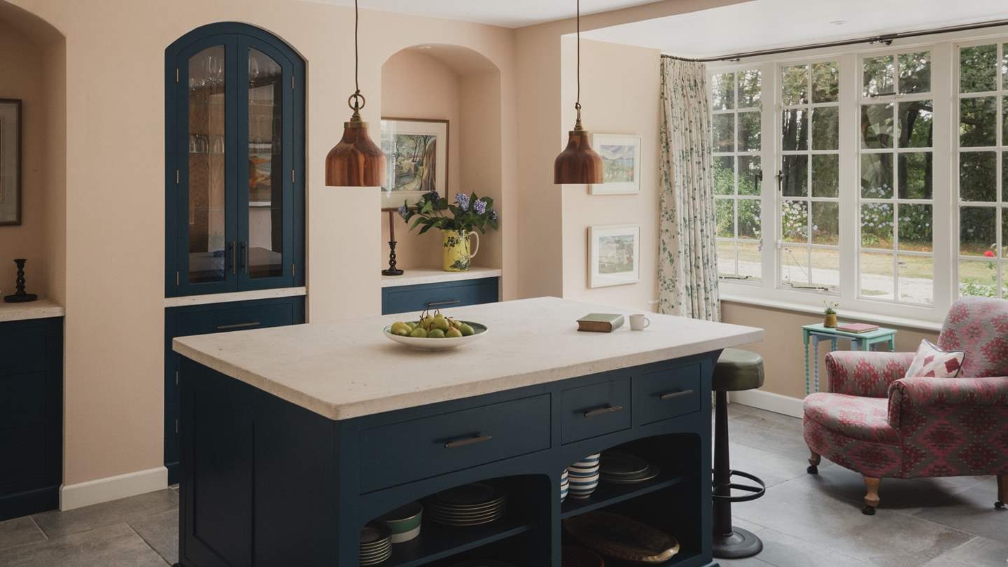 A statement island invites guests to gather for culinary creation in the kitchen