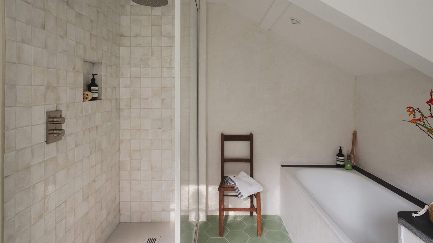 Cloudy Zelligge tiles by Bert and May adorn the spacious rainfall shower in the adjacent ensuite bathroom