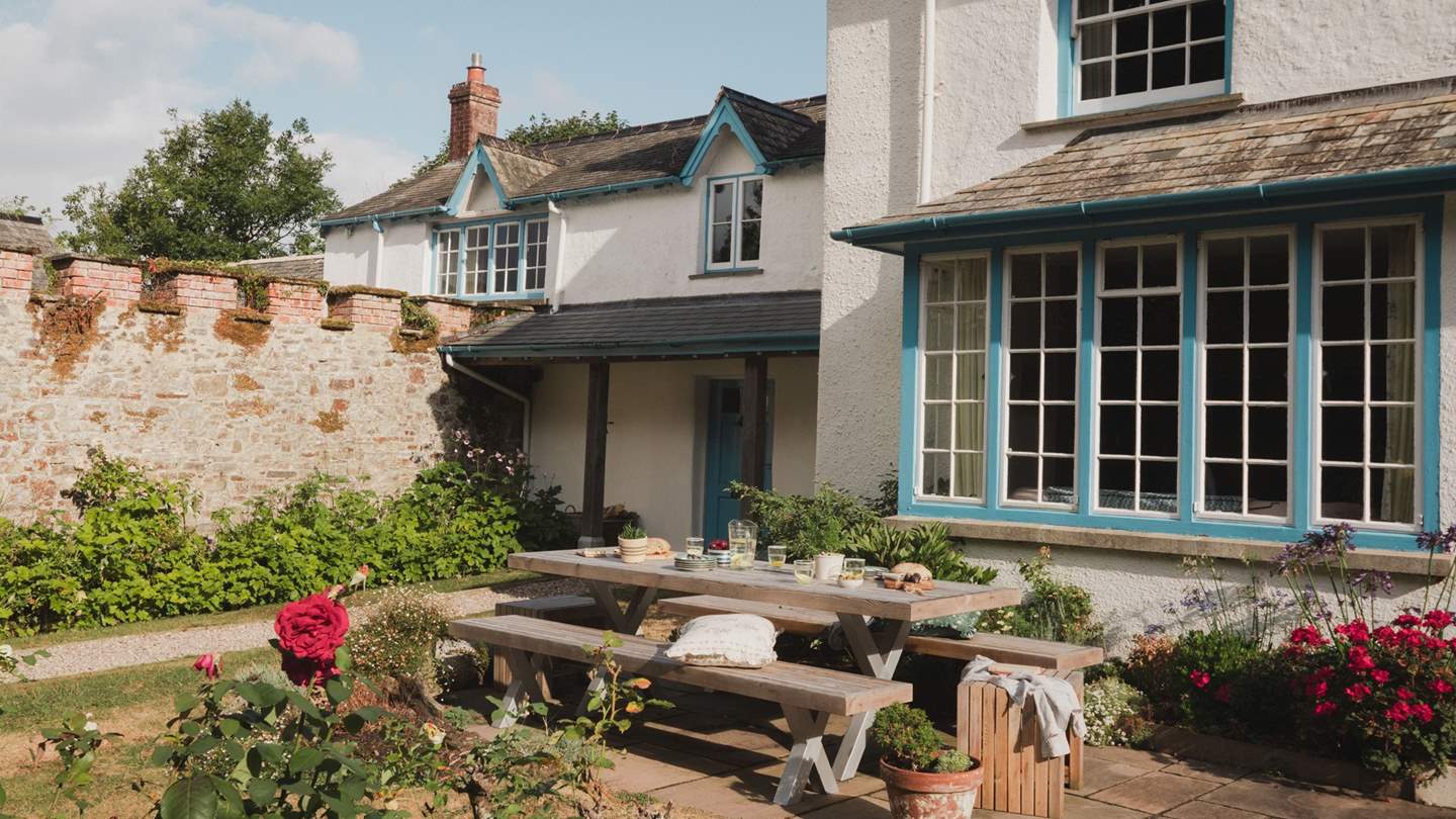 On the sweeping front lawn, a generous table for ten with rustic benches sets the scene for leisurely feasts 