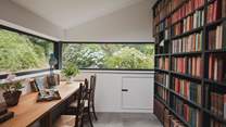 Beyond, a peaceful office with its striking library wall provides a tranquil workspace should inspiration strike