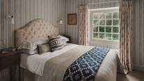 Exuding period charm with a feature fireplace, a double bed awaits