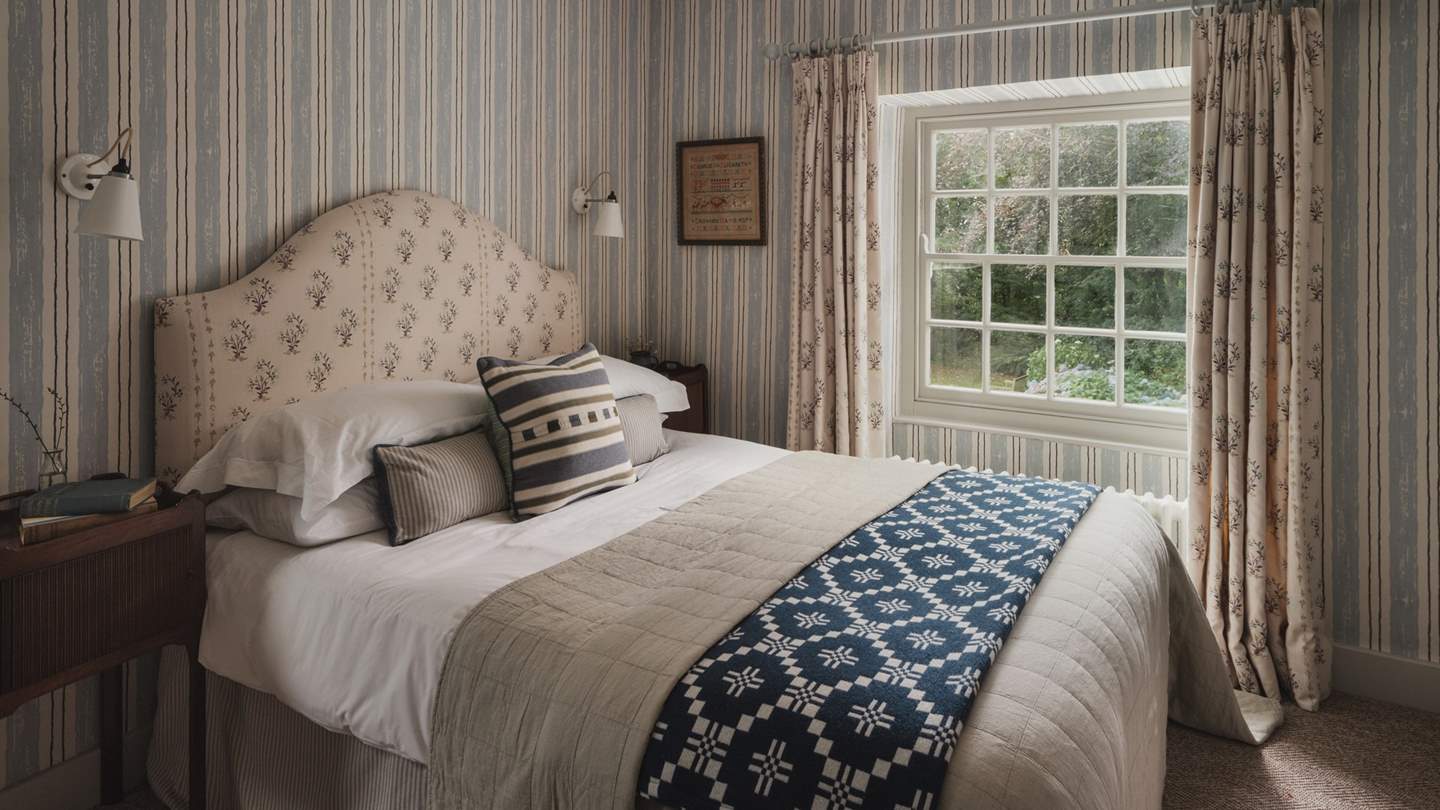 Exuding period charm with a feature fireplace, a double bed awaits