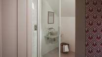 In the ensuite you’ll find stunning terrazzo-style floor tiles and a walk-in shower