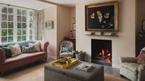 Gather beside the open fire in the formal living room