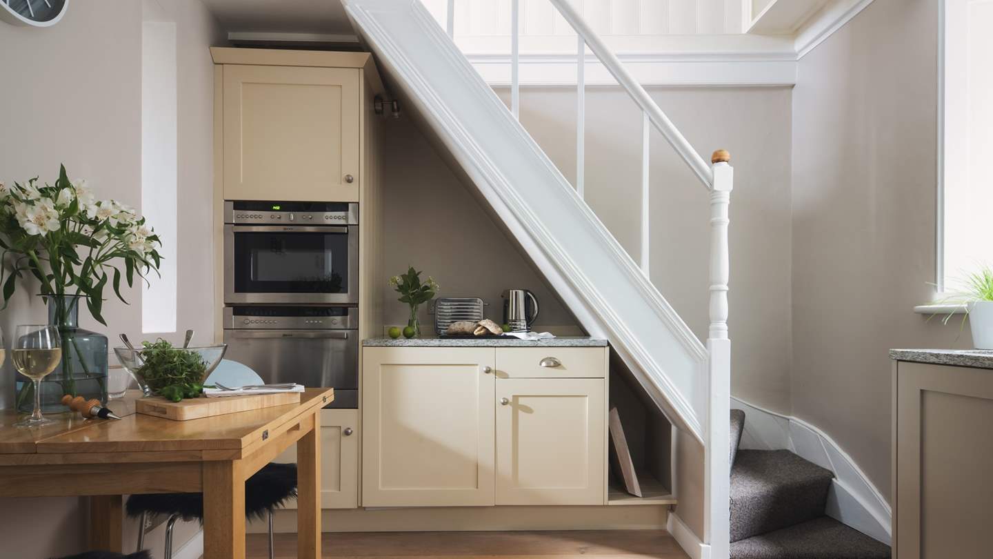 The kitchen is cleverly tucked under the stairs, whilst there's some lovely places to eat just a short walk away