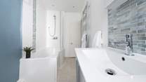 The family bathroom has a bath with a shower over for rejuvenating wake-me ups