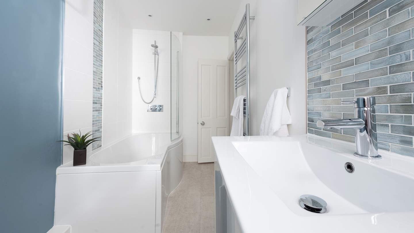The family bathroom has a bath with a shower over for rejuvenating wake-me ups