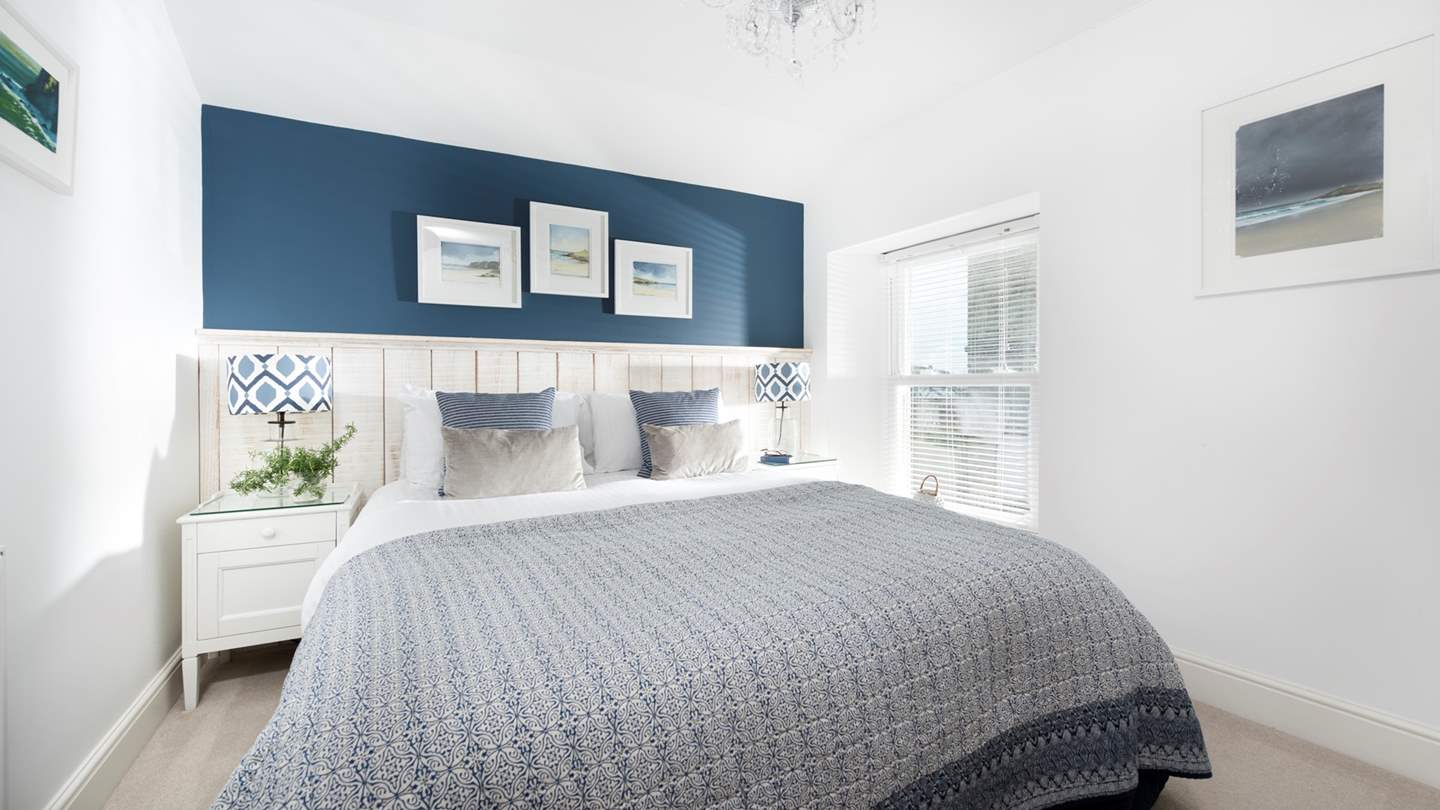 The second bedroom with a king size bed offers elegant endless style...