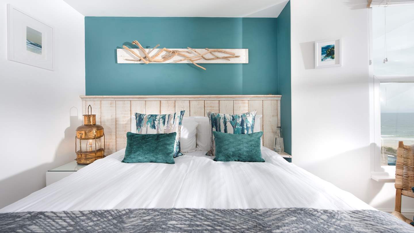 The master bedroom with a sumptuous king size bed, promising dreamy mornings enjoying the magical views across St Ives