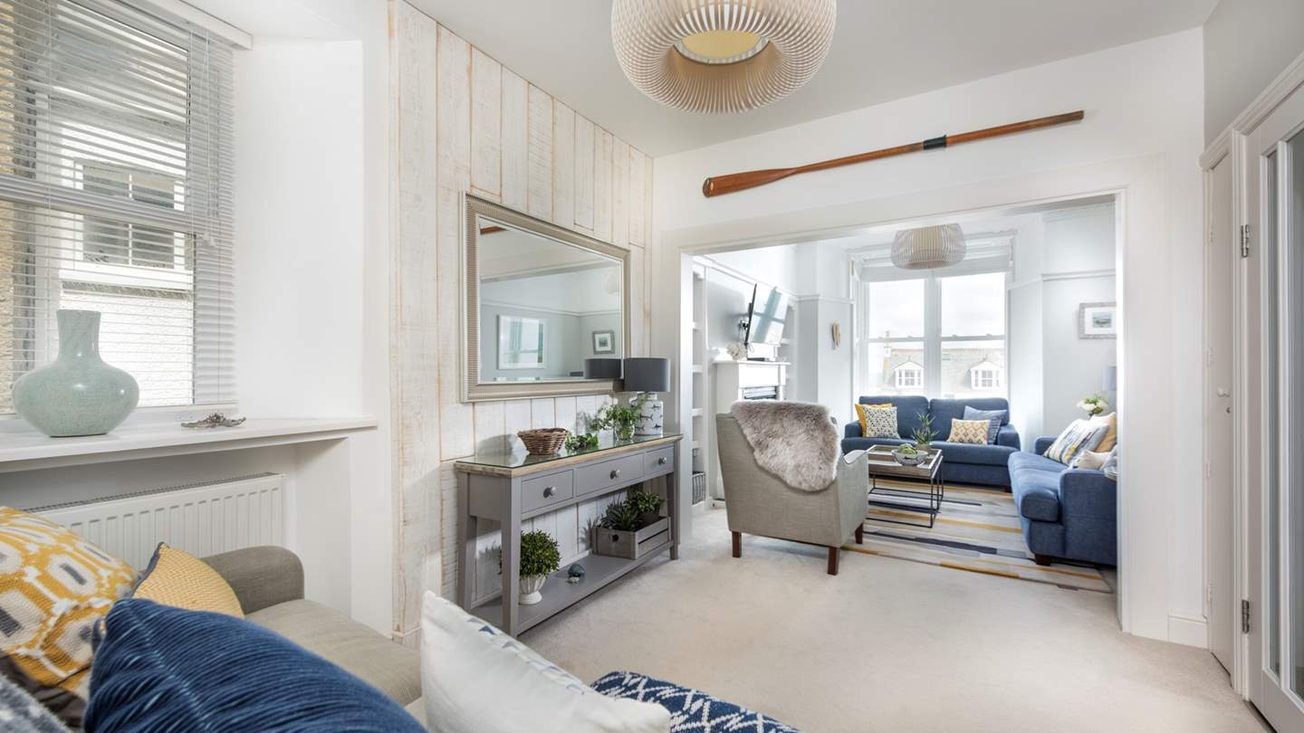 While away the days in the cosy neutral-toned and ocean blue lounge