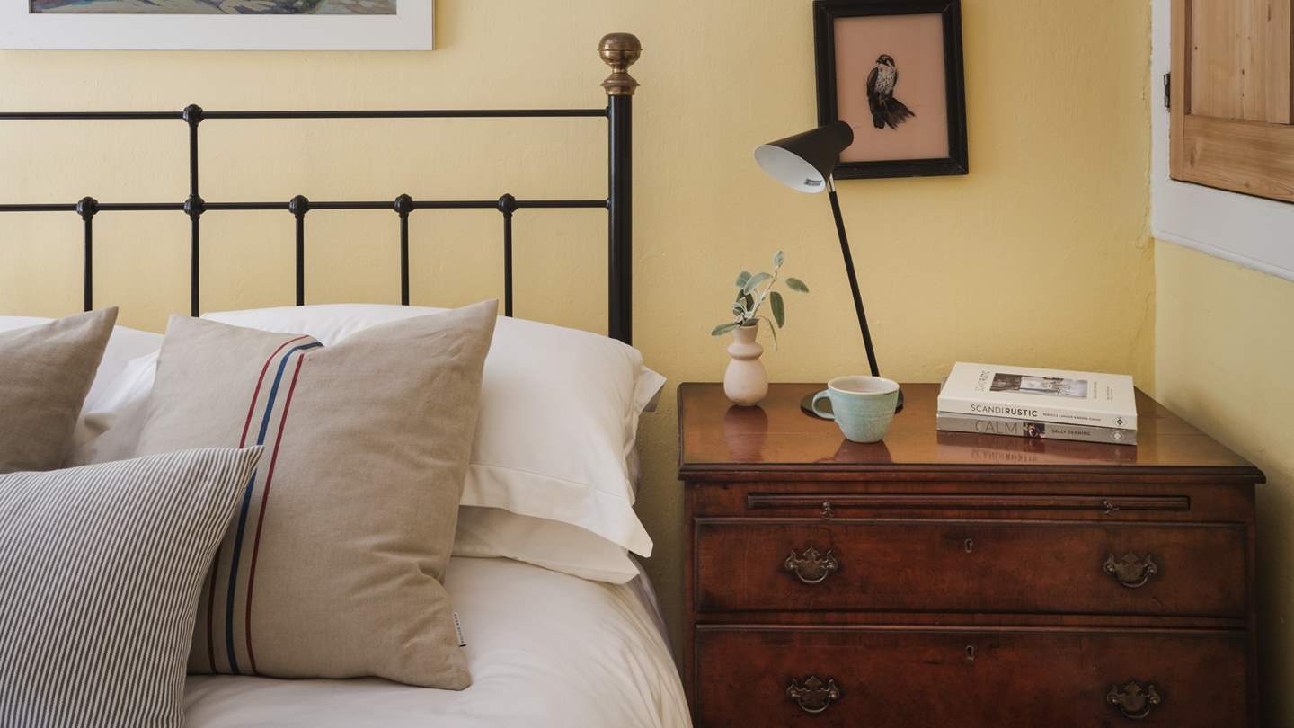 Soothing tones adorn the walls, harmonised with charming artwork of coastal scenes