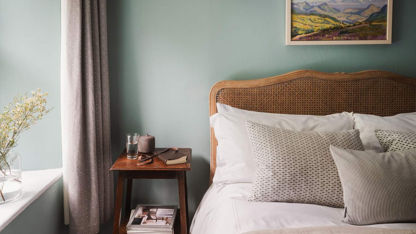 Sea blue tones adorn the walls and dappled light streams in from garden-view windows