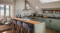 A stylish kitchen with granite worktops, gas hob, electric oven and beautifully painted cupboards