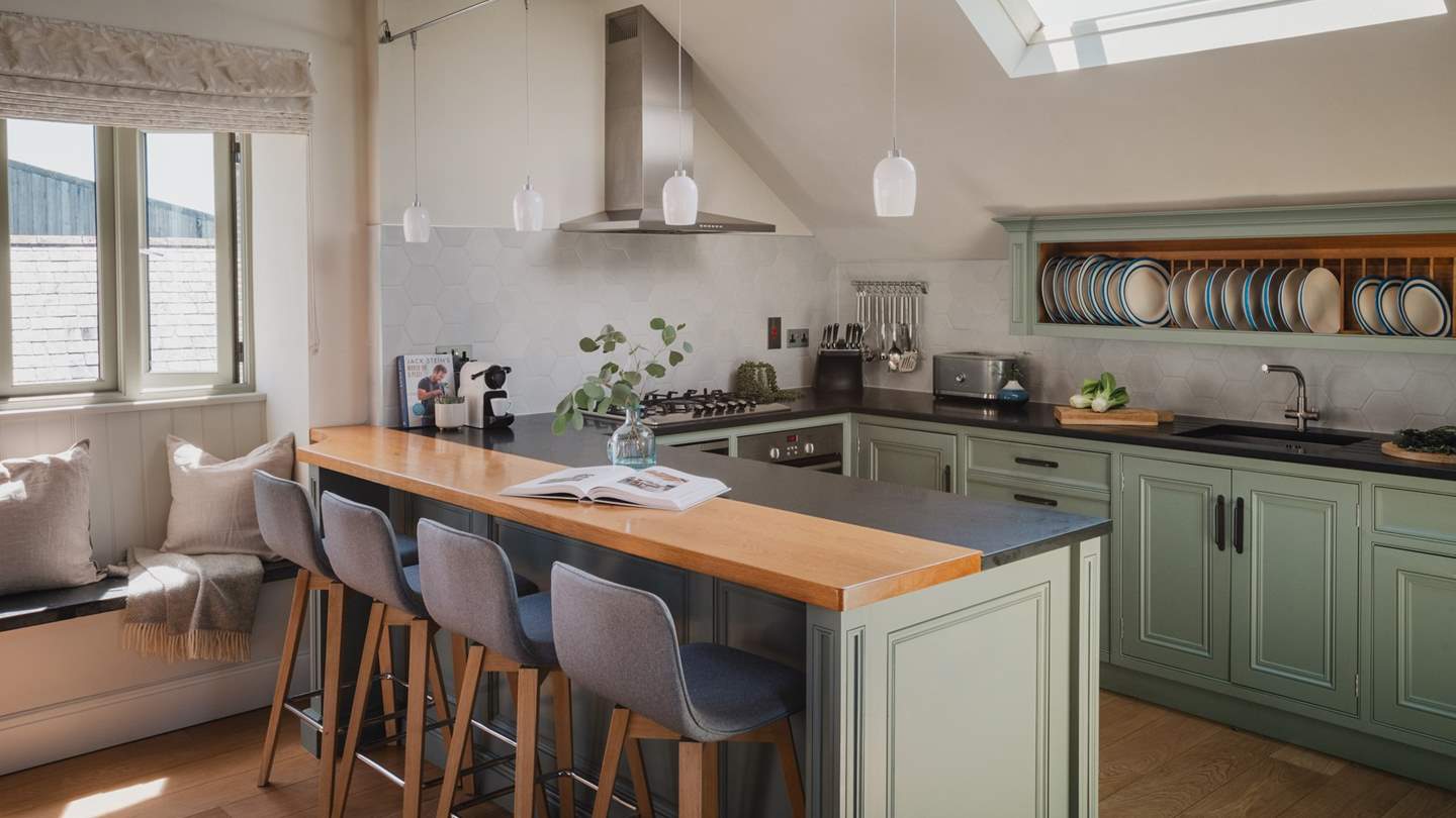 A stylish kitchen with granite worktops, gas hob, electric oven and beautifully painted cupboards
