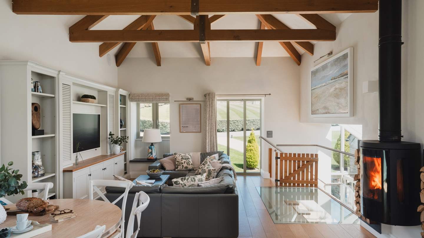 From the elegant light filled foyer head up the beautiful bespoke oak staircase to the enormous open plan living area with a huge, super soft leather suite flanking the large TV/DVD player

