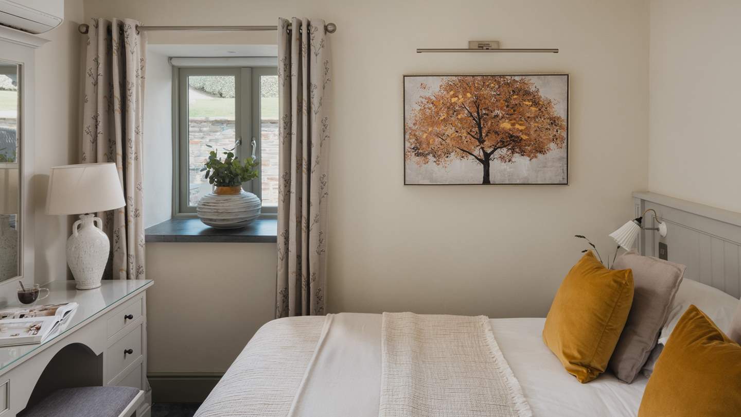 An elegant dressing table lies at the edge of the bed 